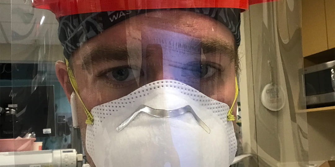 Dr. Luke Frey wearing a face helmet & a n95 mask