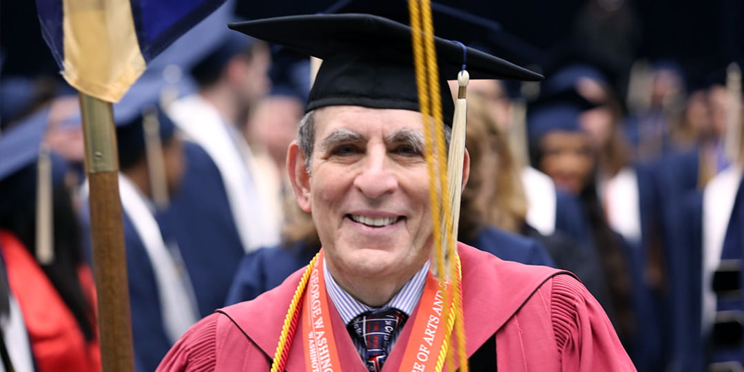 Professor of Chemistry Michael King serving as Columbian College Marshal during a graduation ceremony